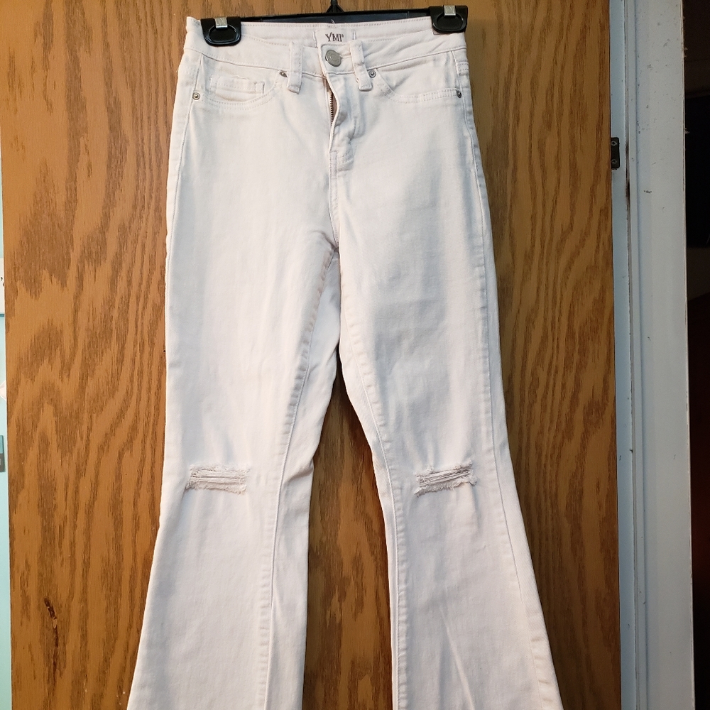 Cute white jeans, ripped at knees with flare bottoms. Great condition.